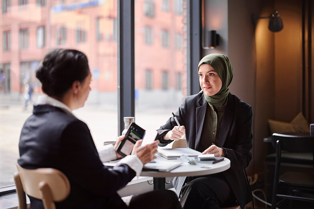 Two businesswomen sitting in cafe