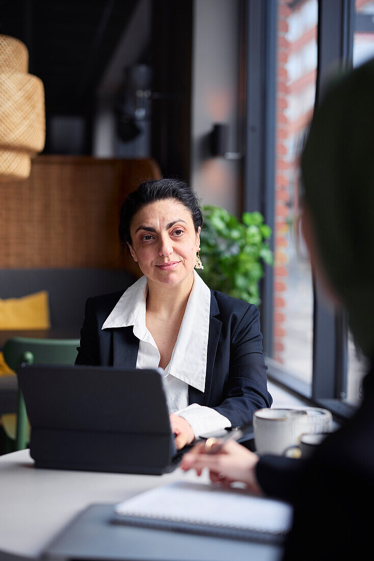 Businesswoman in cafe looking away