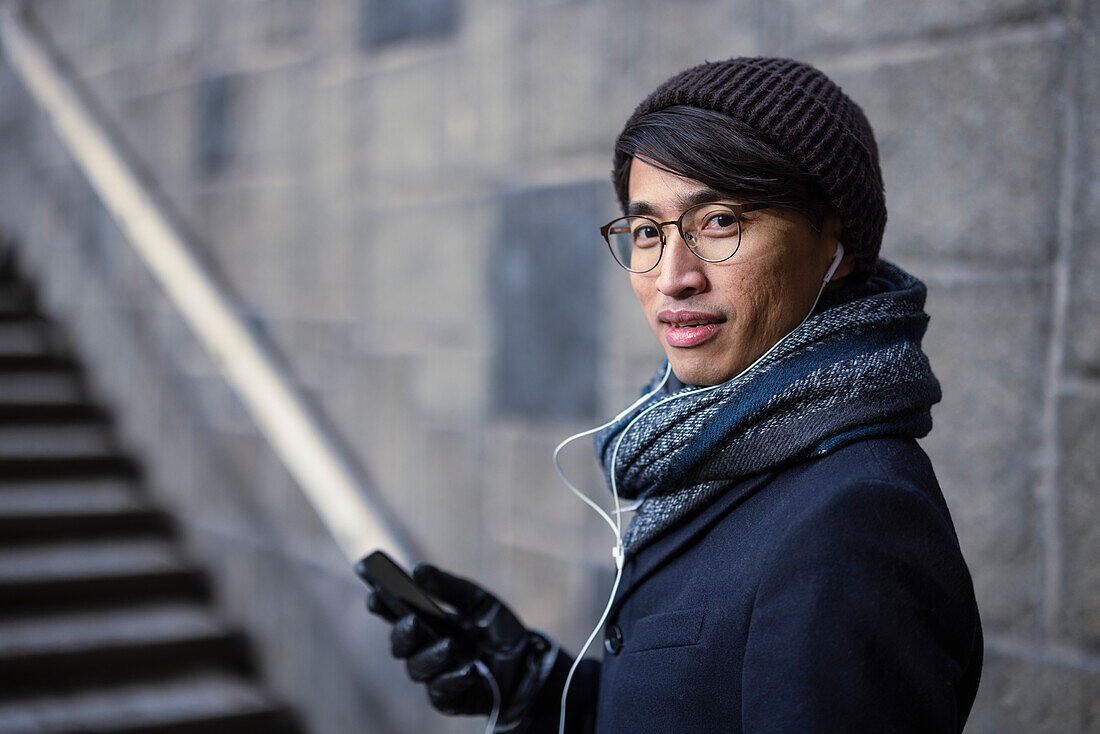 Handsome man with smartphone on street