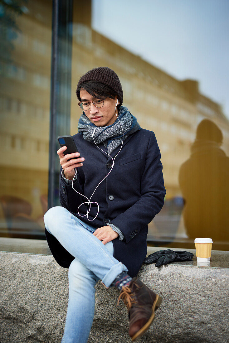 Smiling man using cell phone