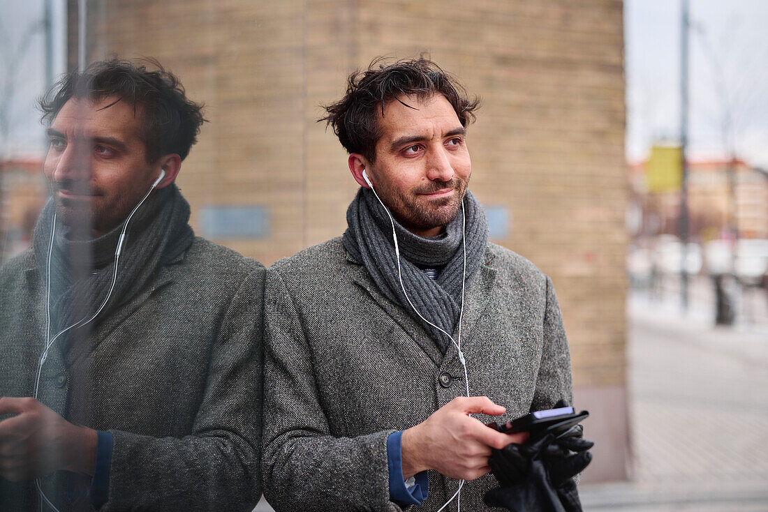 Elegant man with smartphone on street