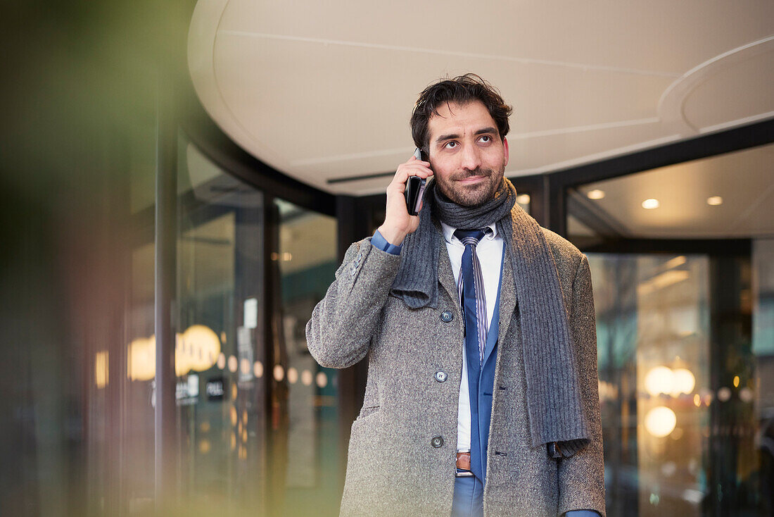Businessman talking on phone outdoors