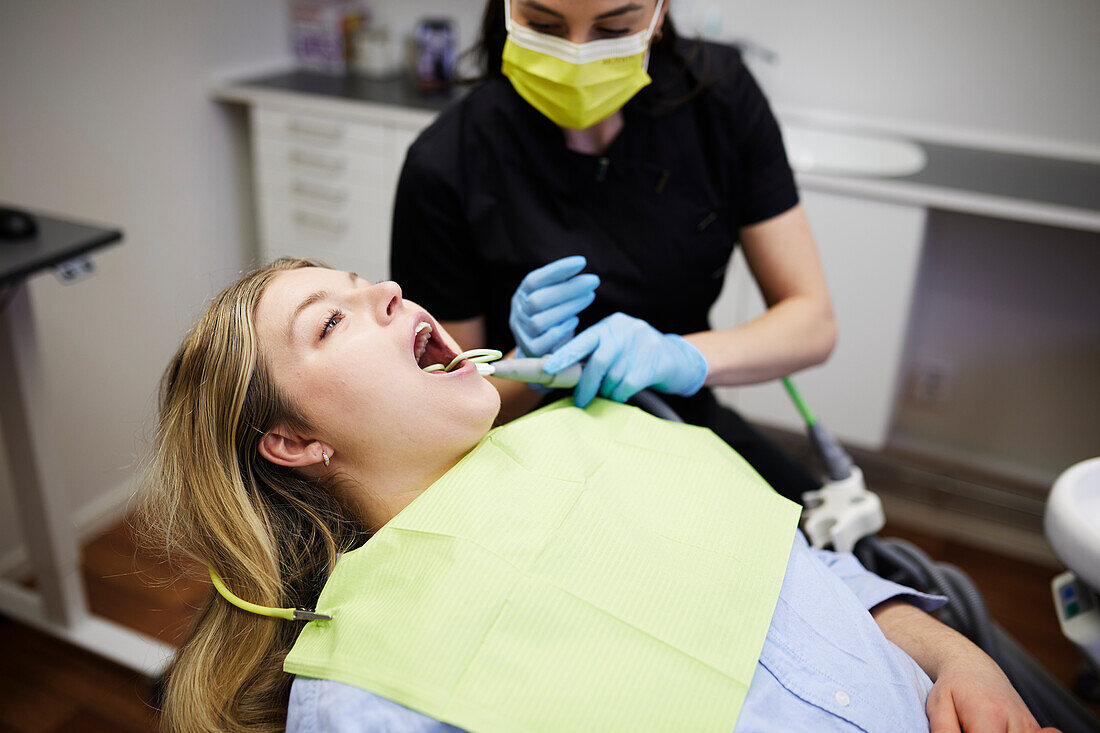 Female dentist with patient in office