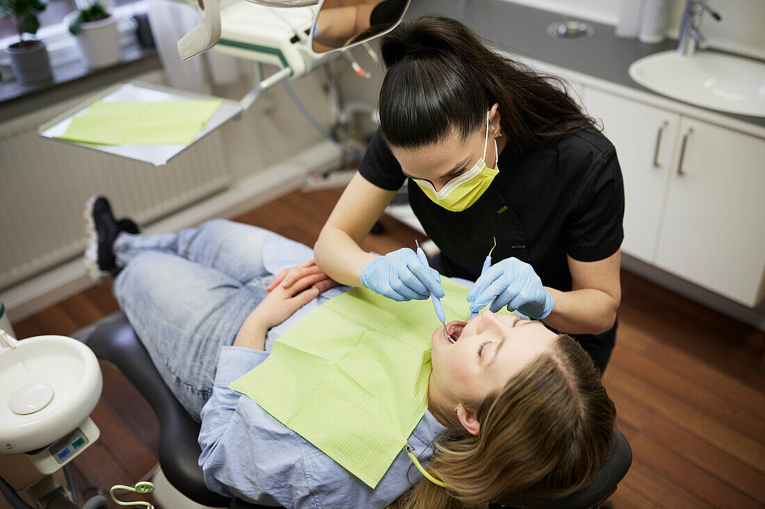 Female dentist with patient in office