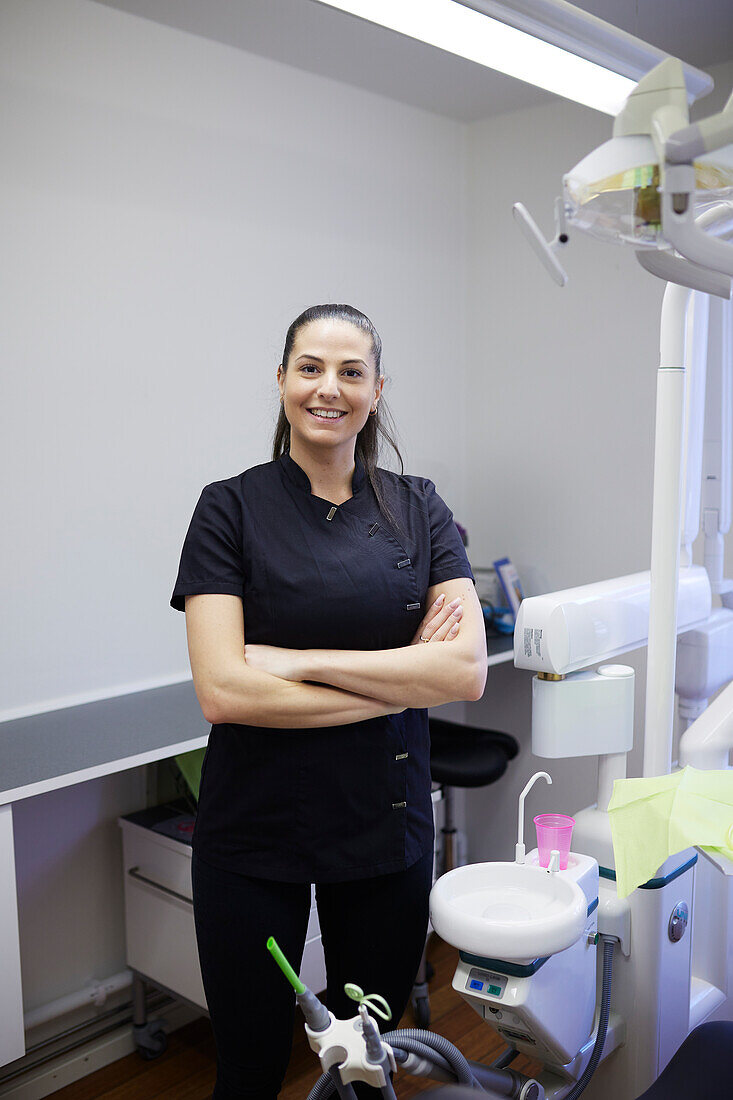 Female dentist standing in office