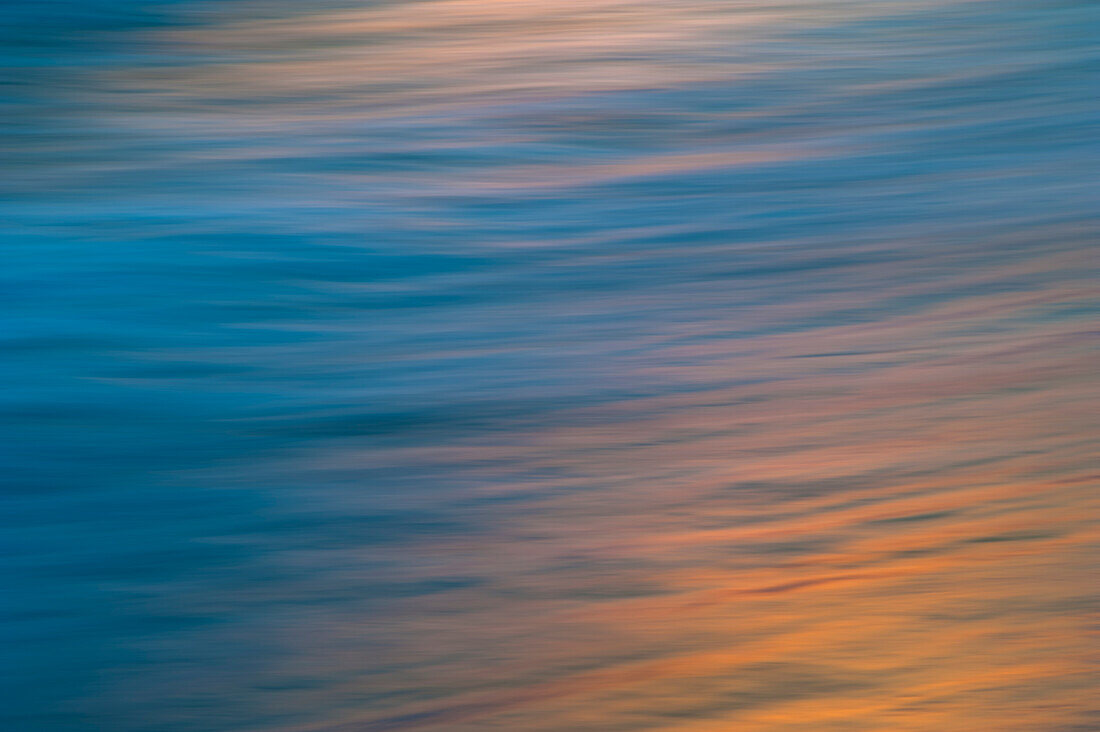 Undulating waves reflecting the sunset colors