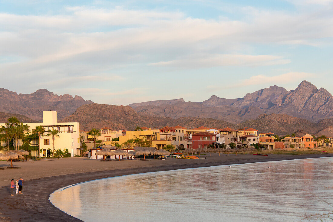 Mexico, Baja California Sur, Sea of Cortez. Loreto Bay Golf Resort and Spa. Beach walkers stop to observe wildlife in bay