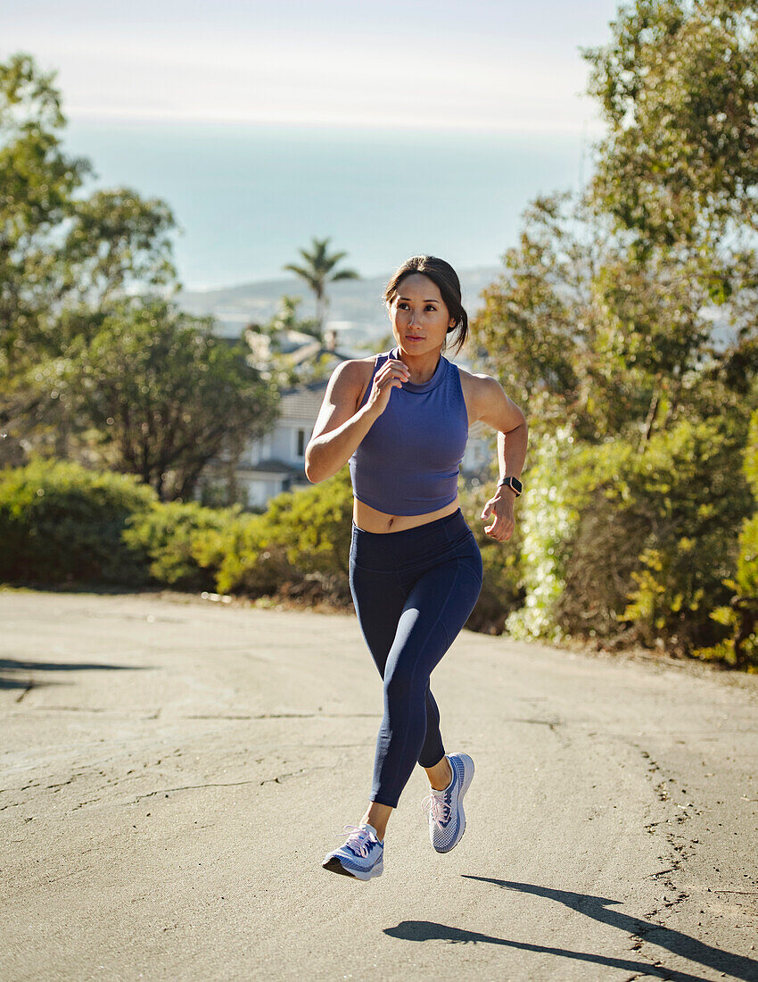 Woman jogging on country road