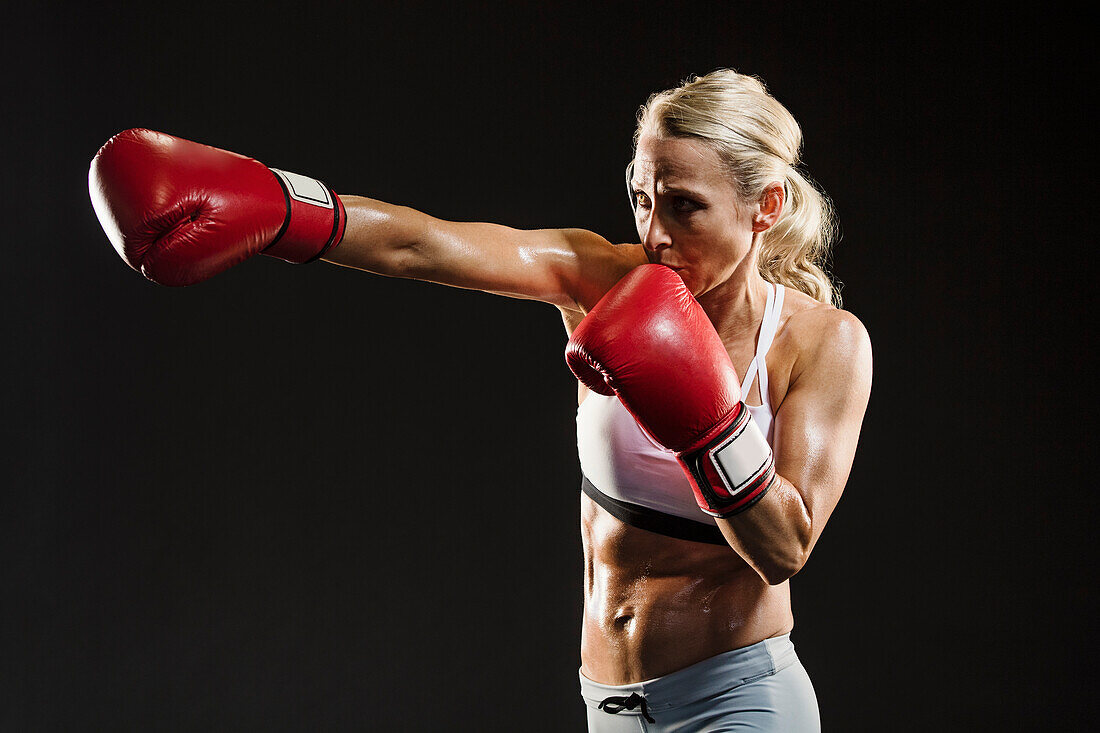 Studio shot of athlete woman boxing