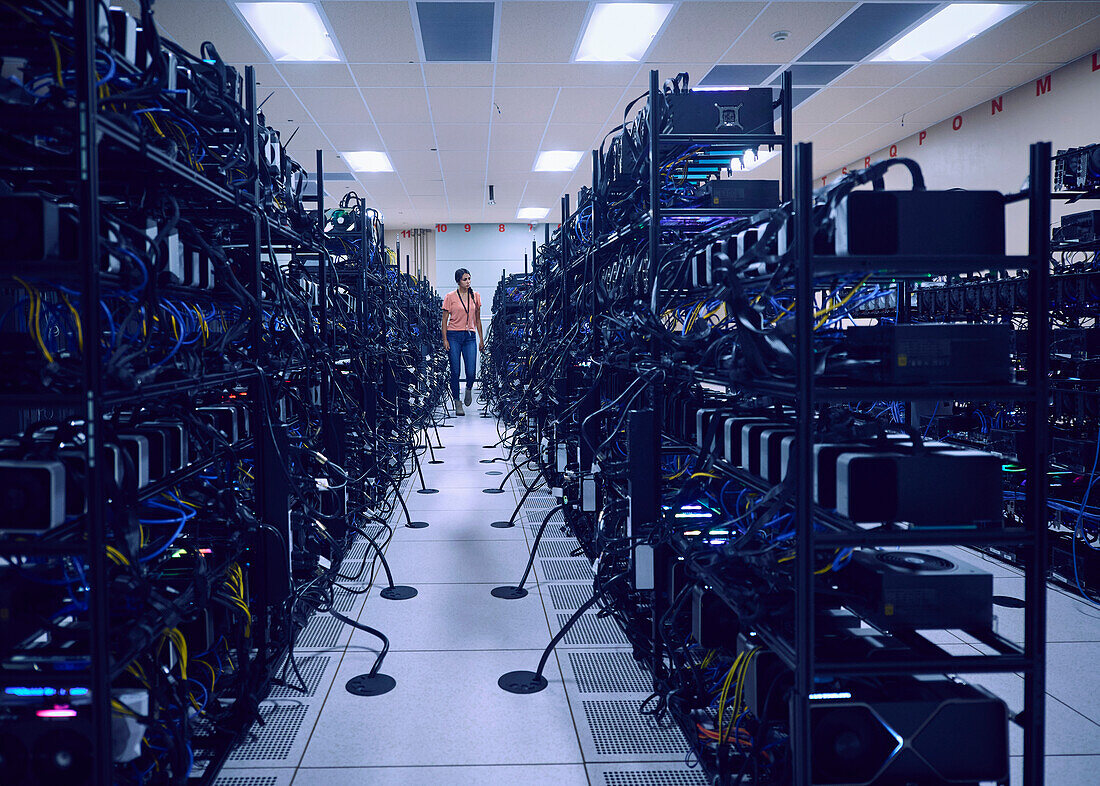 Female technician working in server room