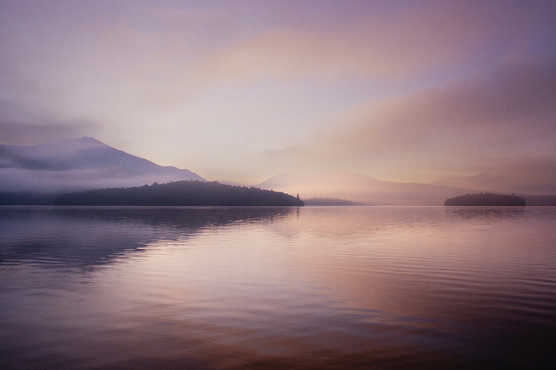 United States, New York, St. Armand, Morning mist rising on Lake Placid, Adirondacks State Park
