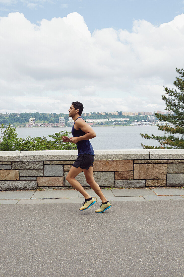 USA, New York, New York City, Man jogging in city