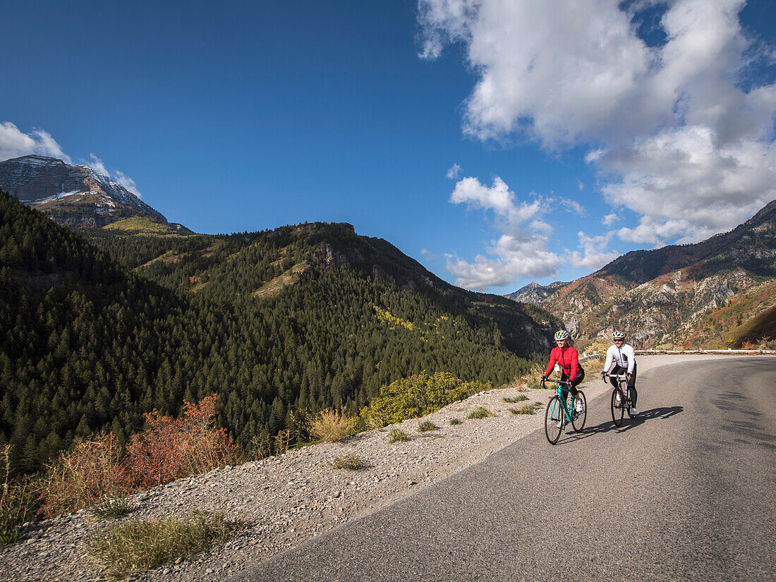 United States, Utah, American Fork, Man and woman riding bicycles on mountain road