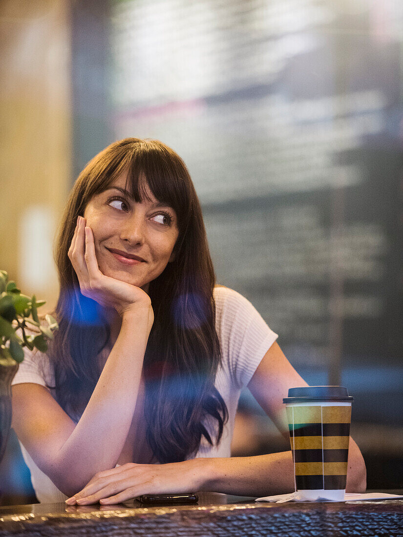 Smiling woman sitting in cafe