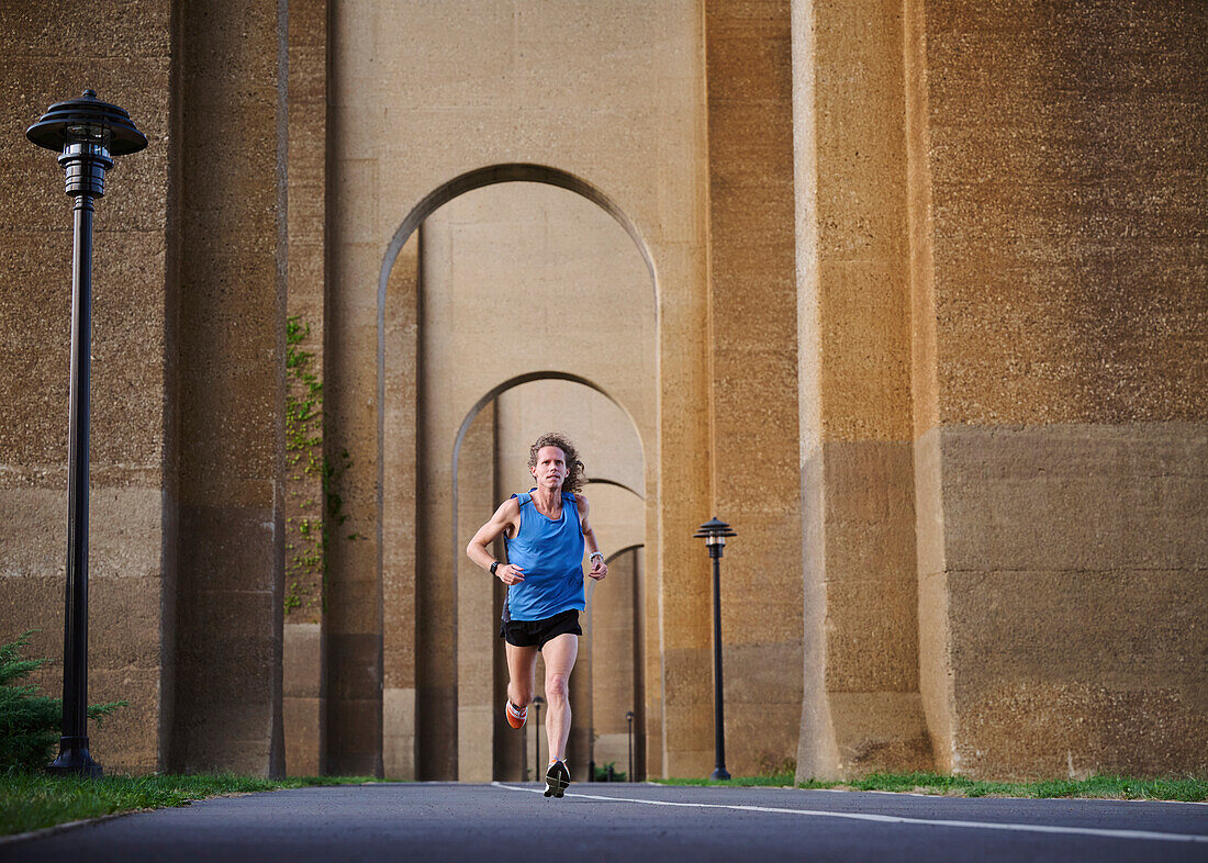 Man jogging under bridge