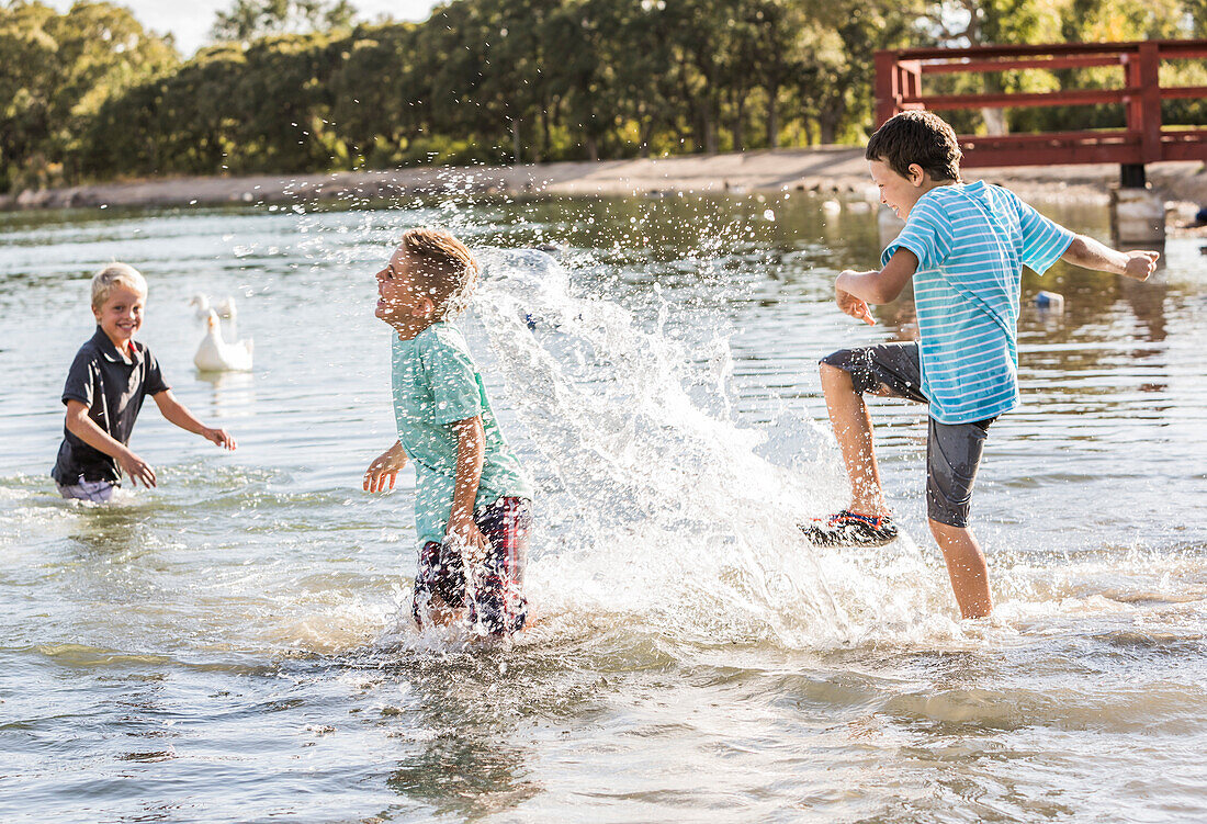 Boys (8-9) playing in lake