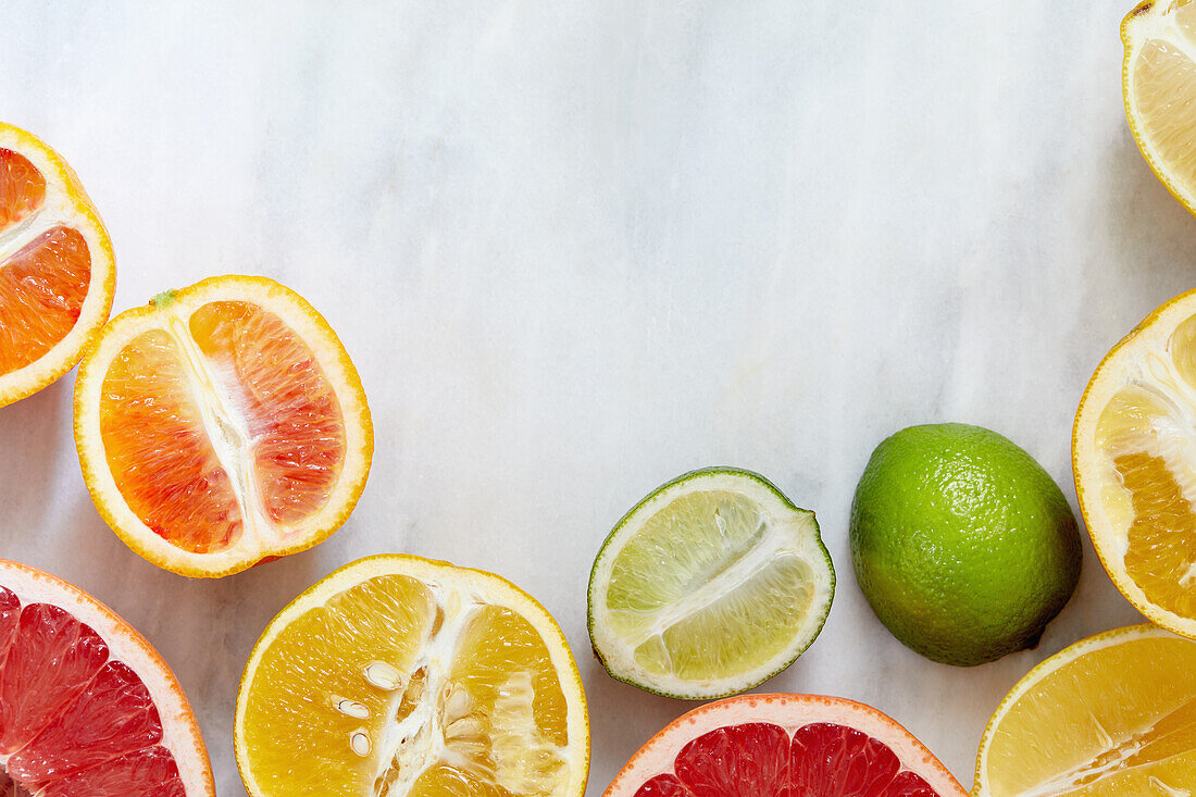 Overhead view of citrus fruit on marble surface