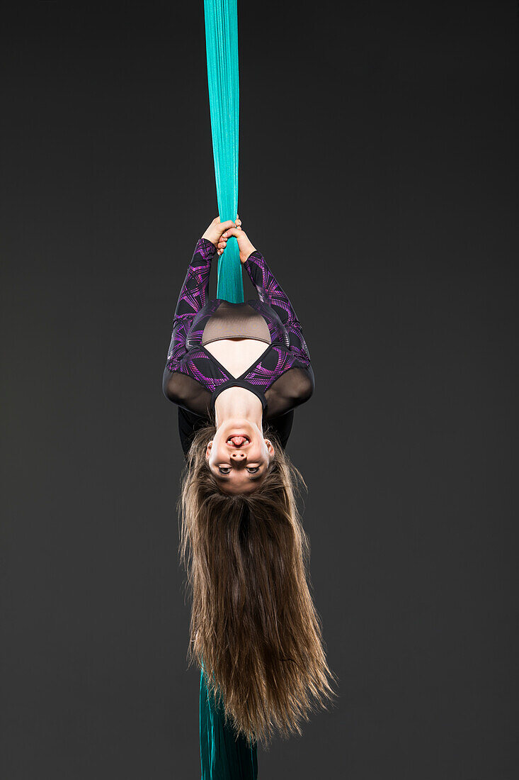 Teenage girl (14-15) during aerial silk practice