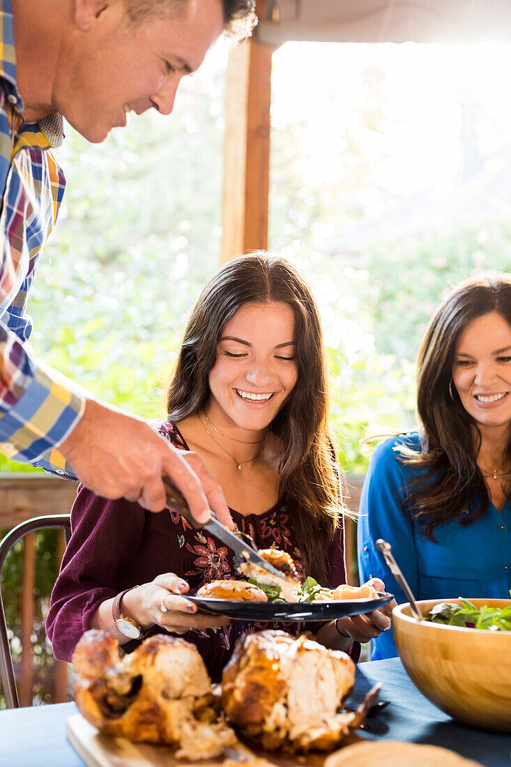 Family with daughter (10-11) eating dinner