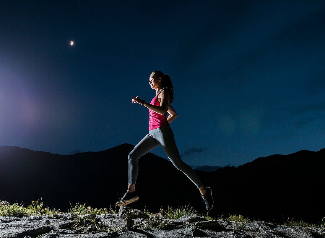 United States, Utah, Alpine, Woman jogging in mountains at night