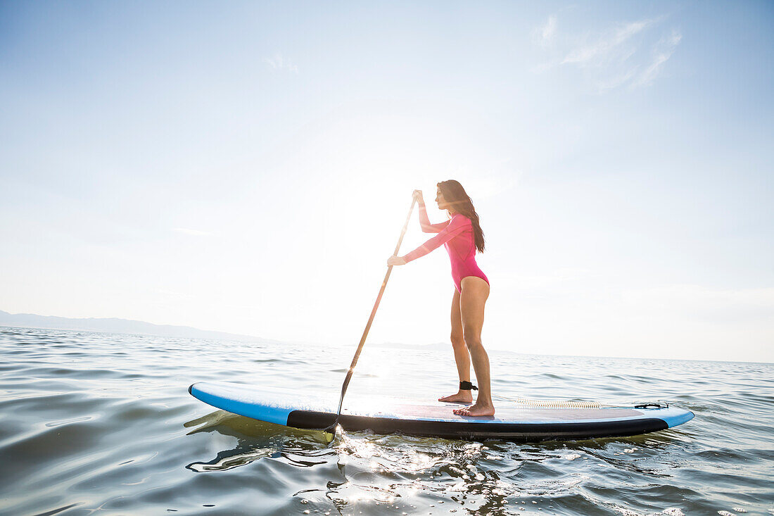 Woman paddleboarding on lake