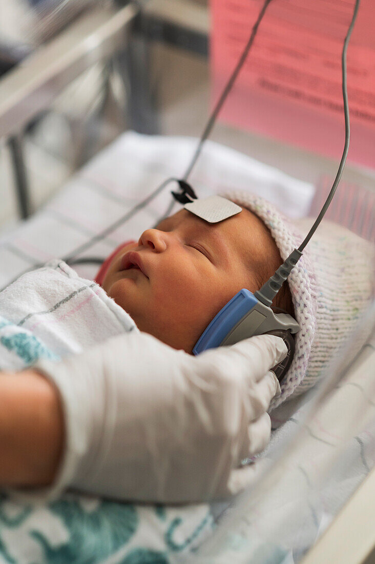 Infant baby girl (0-1 months) having hearing test done