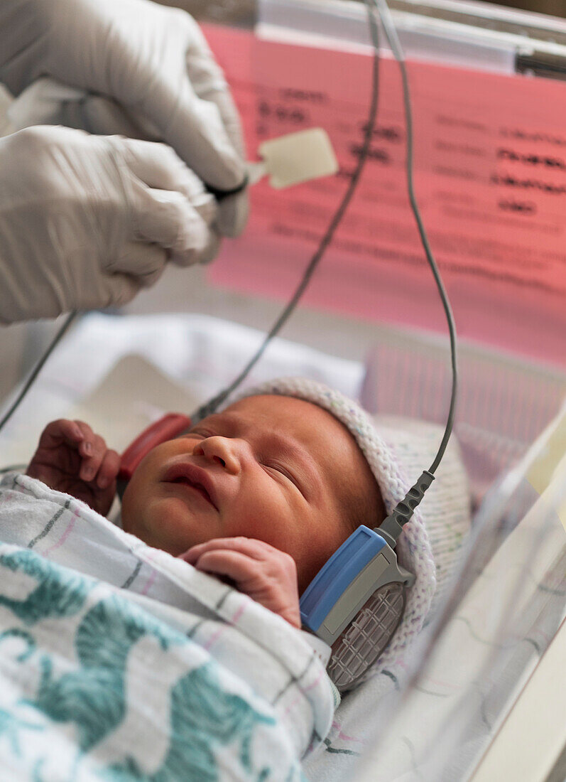 Infant baby girl (0-1 months) having hearing test done