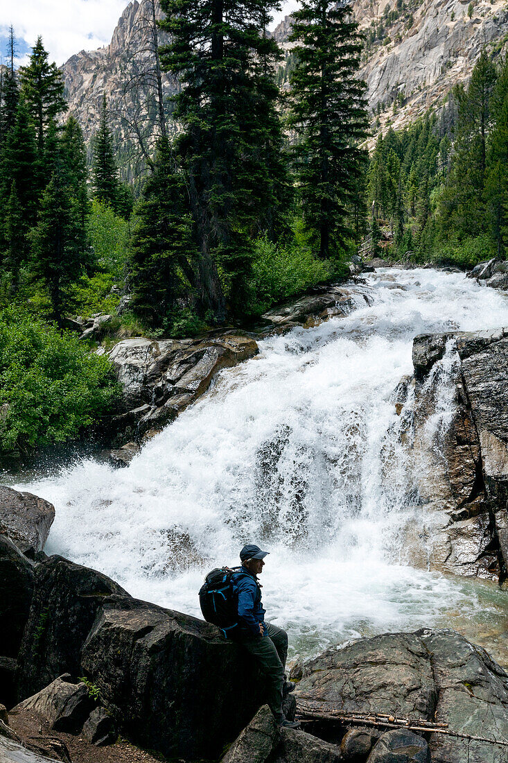 USA, Idaho, Stanley, Man hiking by mountain waterfall near Sun Valley