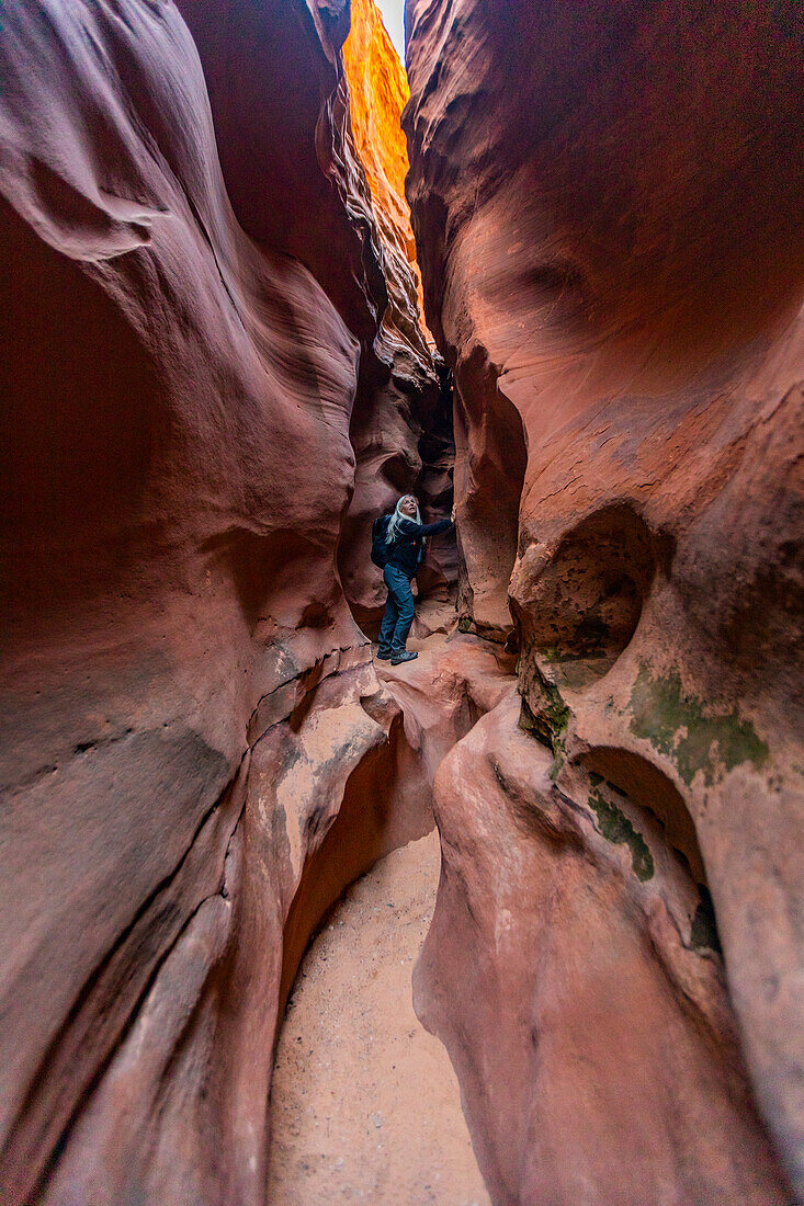 United States, Utah, Escalante, Senior hiker exploring slot canyon