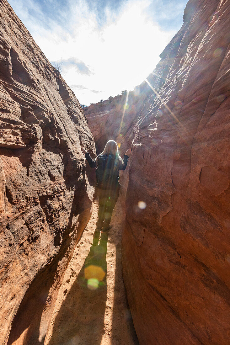 United States, Utah, Escalante, Senior hiker exploring slot canyon