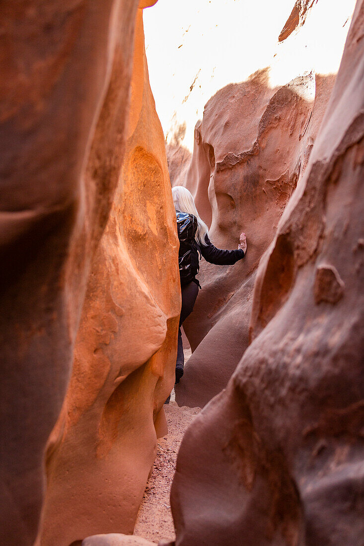 United States, Utah, Escalante, Senior hiker exploring slot canyon