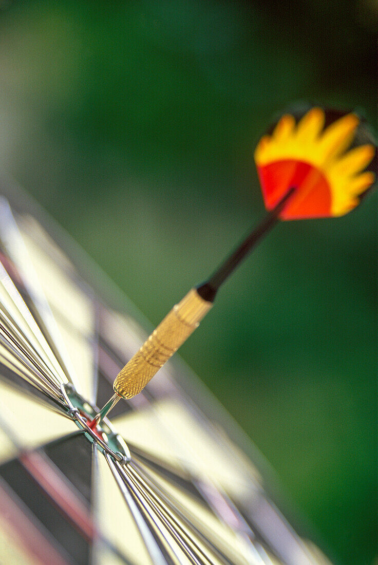 Dart arrow in target center of dartboard