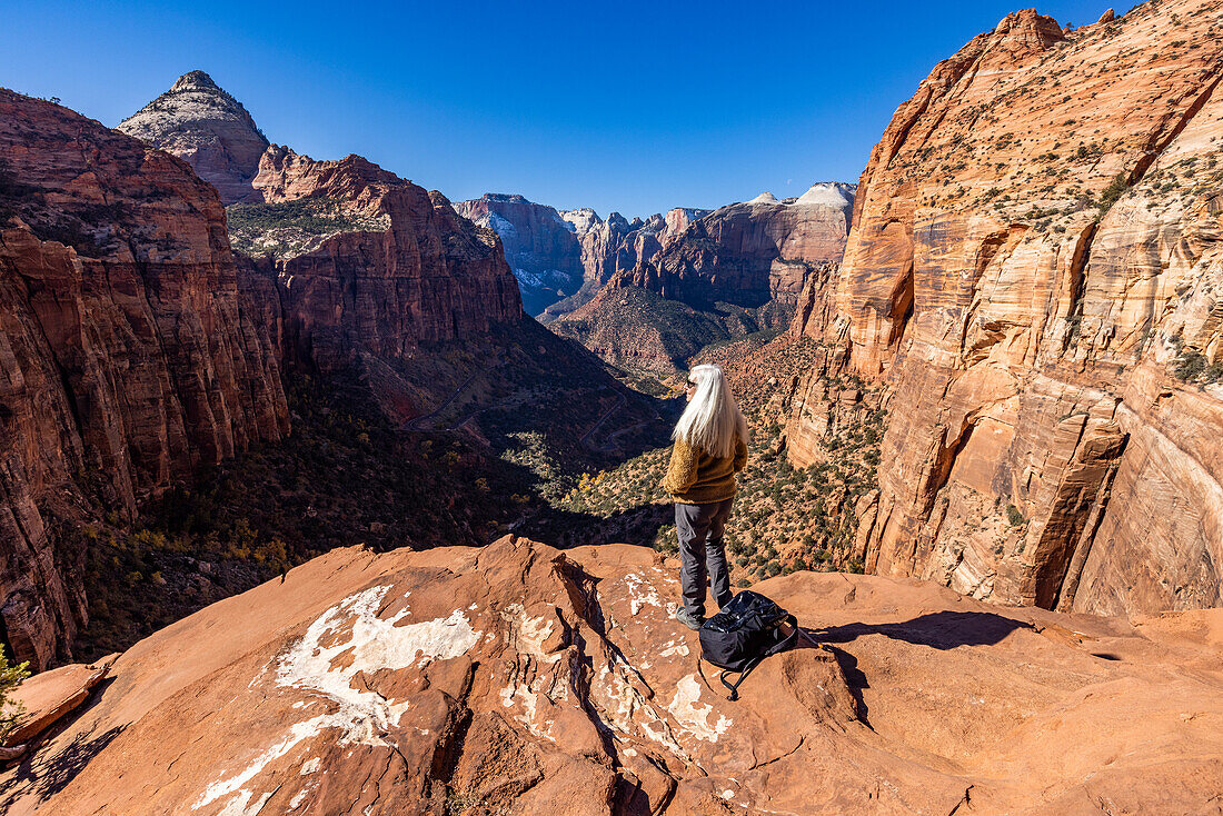 USA, Utah, Zion National Park, Senior female hiker at overlook of Zion National Park