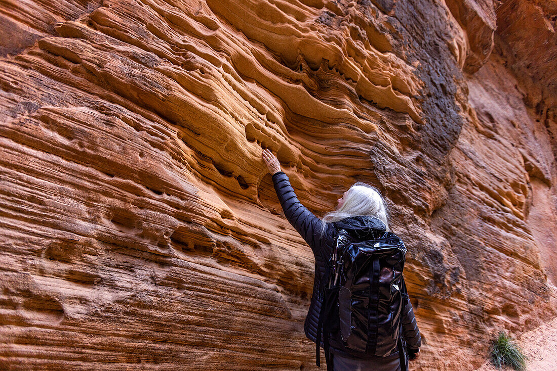United States, Utah, Zion National Park, Senior blond woman hiking
