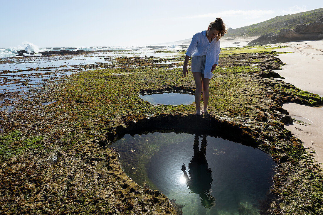 South Africa, Western Cape, Girl (16-17) exploring tidal pools in Lekkerwater Nature Reserve
