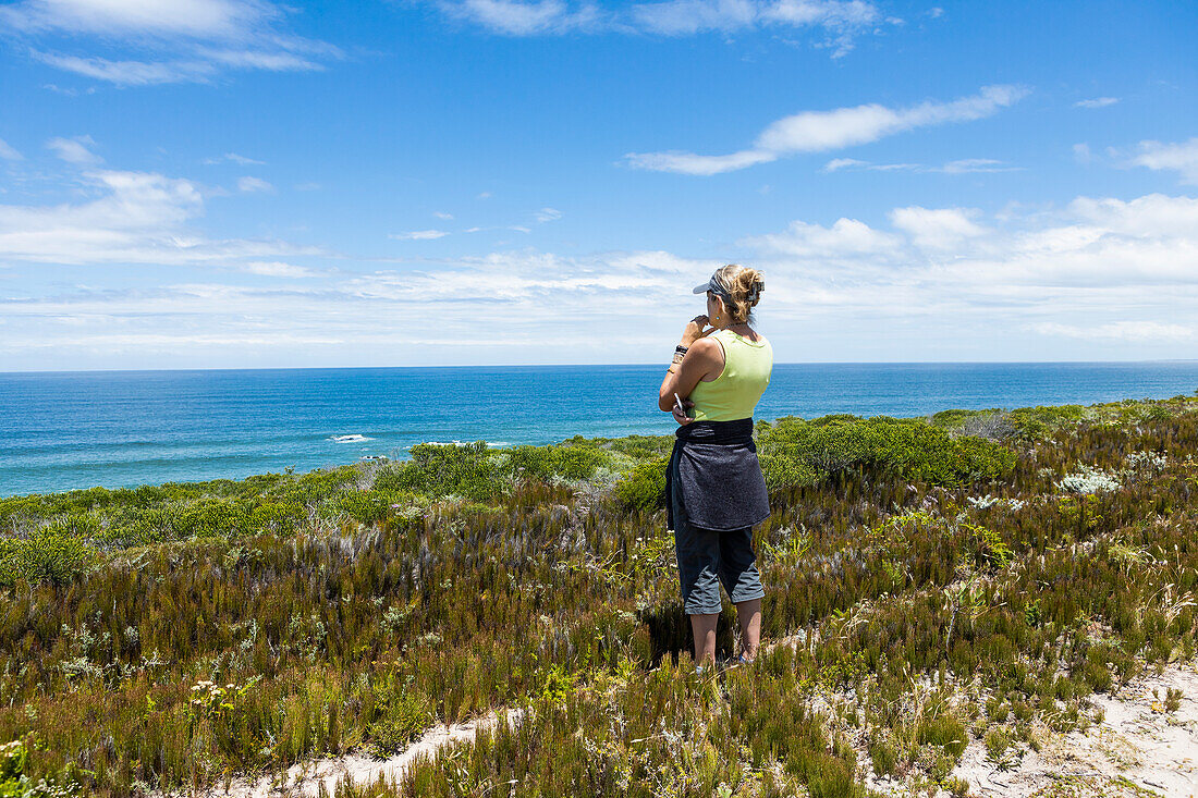 South Africa, Western Cape, Woman looking at ocean view in Lekkerwater Nature Reserve