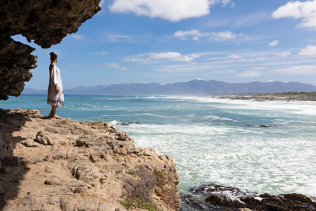South Africa, Western Cape, Girl (16-17) exploring rock formations in Walker Bay Nature Reserve