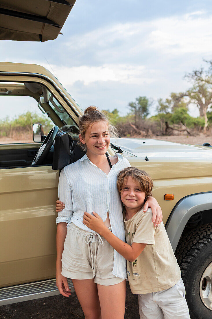 Africa, Namibia, Brother (8-9) and sister (16-17) on safari