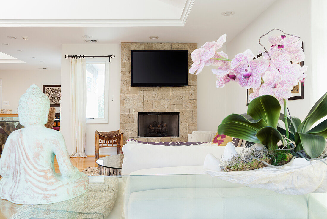 Orchids and Buddha statue in living room