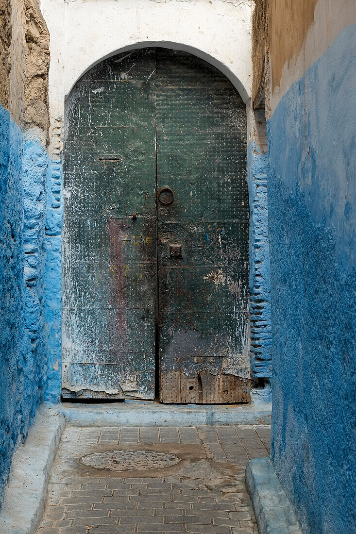 Africa, Morocco, Colorful blue walls and old door in alleyway in medina