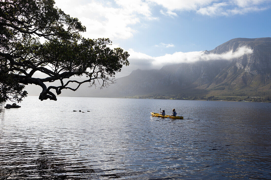 South Africa, Stanford, Boy and teenage girl (10-11, 16-17) kayaking in lagoon