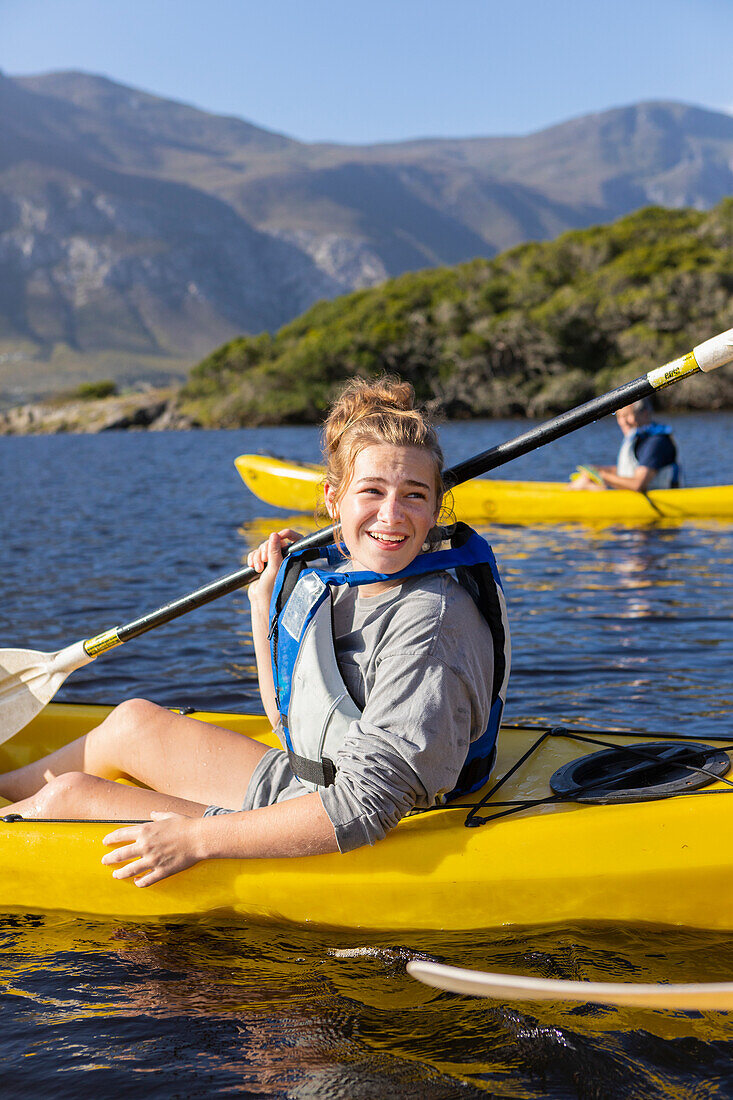 South Africa, Stanford, Smiling teenage girl (16-17) kayaking in lagoon