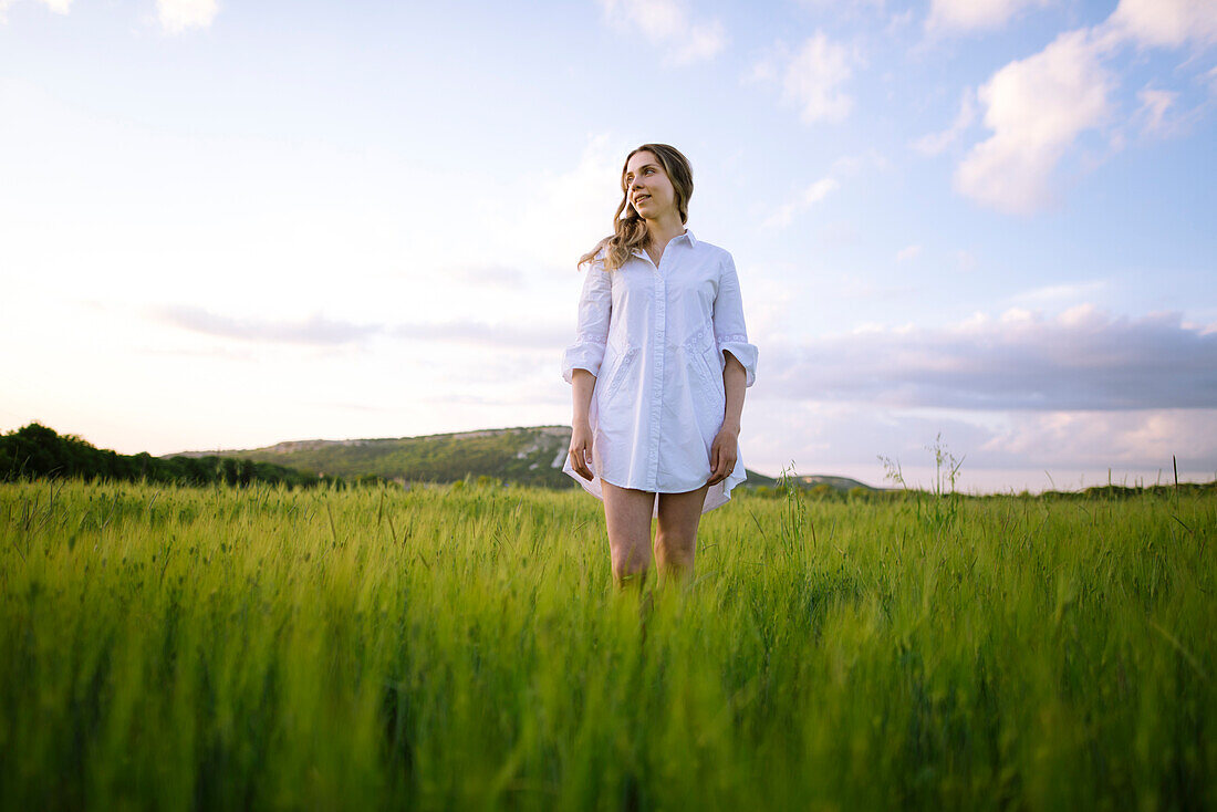 Young woman standing in agricultural field