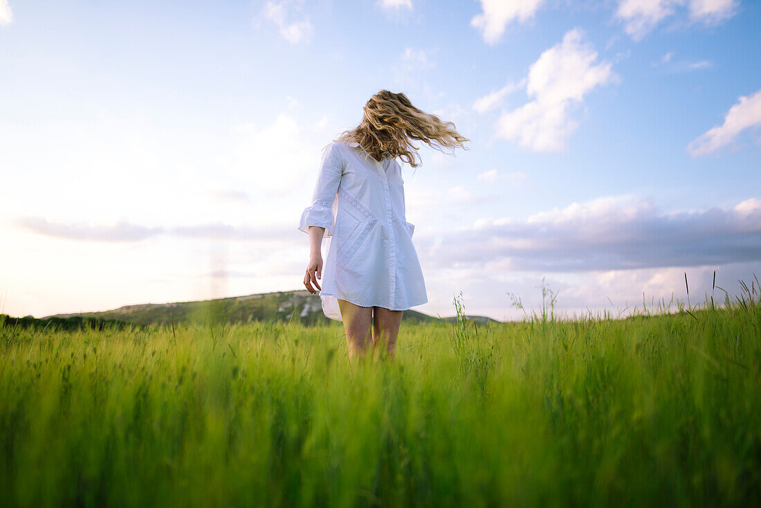 Young woman standing in agricultural field