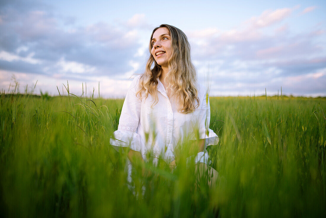 Young woman standing in agricultural field