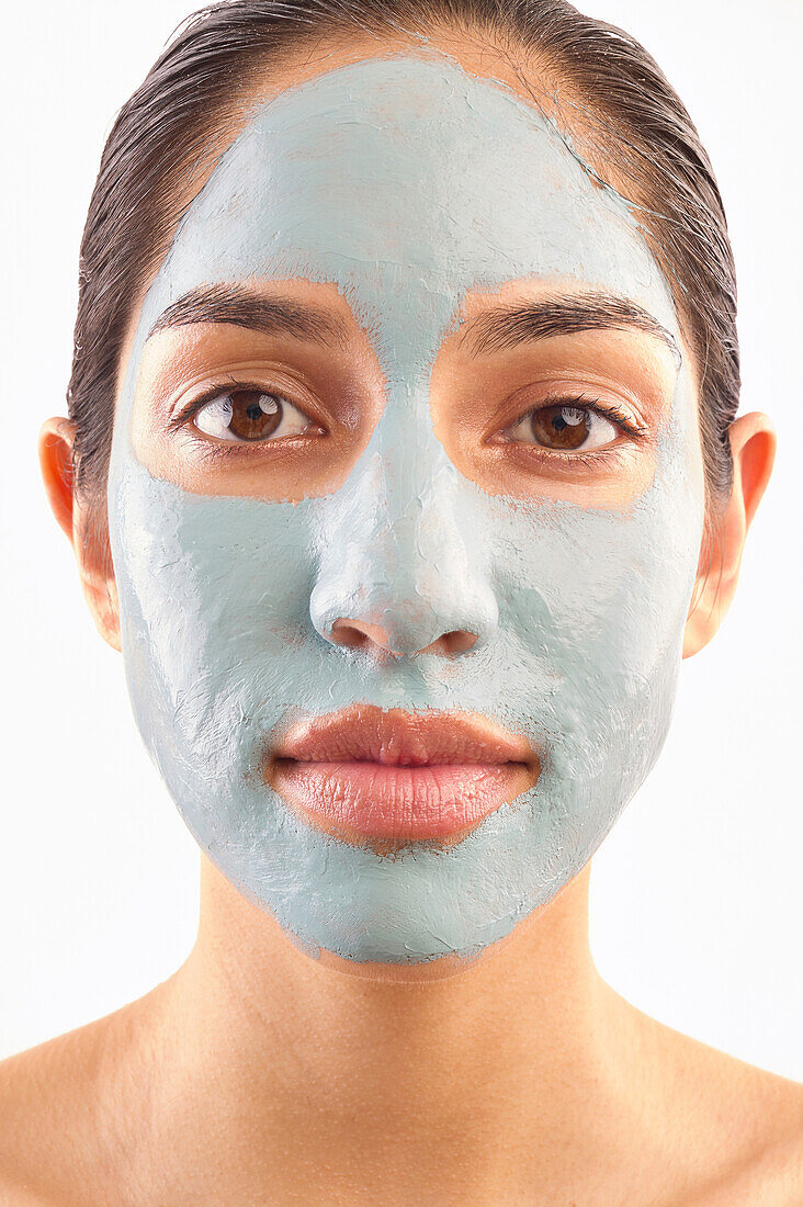 Studio portrait of woman with blue facial mask
