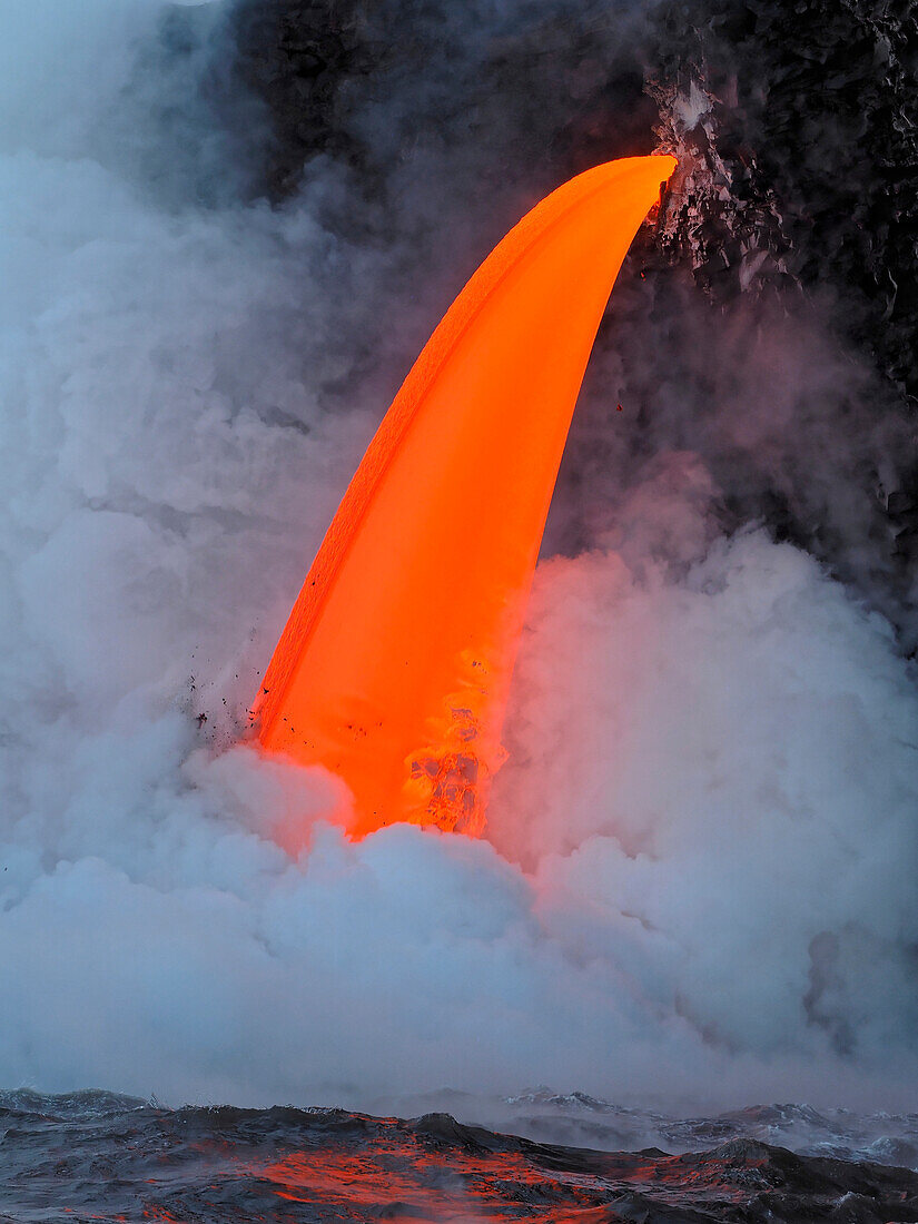 USA, Hawaii, Big Island. Lava from the Big Island's Pu'u O'o eruption flowing into the ocean on the Kalapana coast, Hawaii Volcanoes National Park.