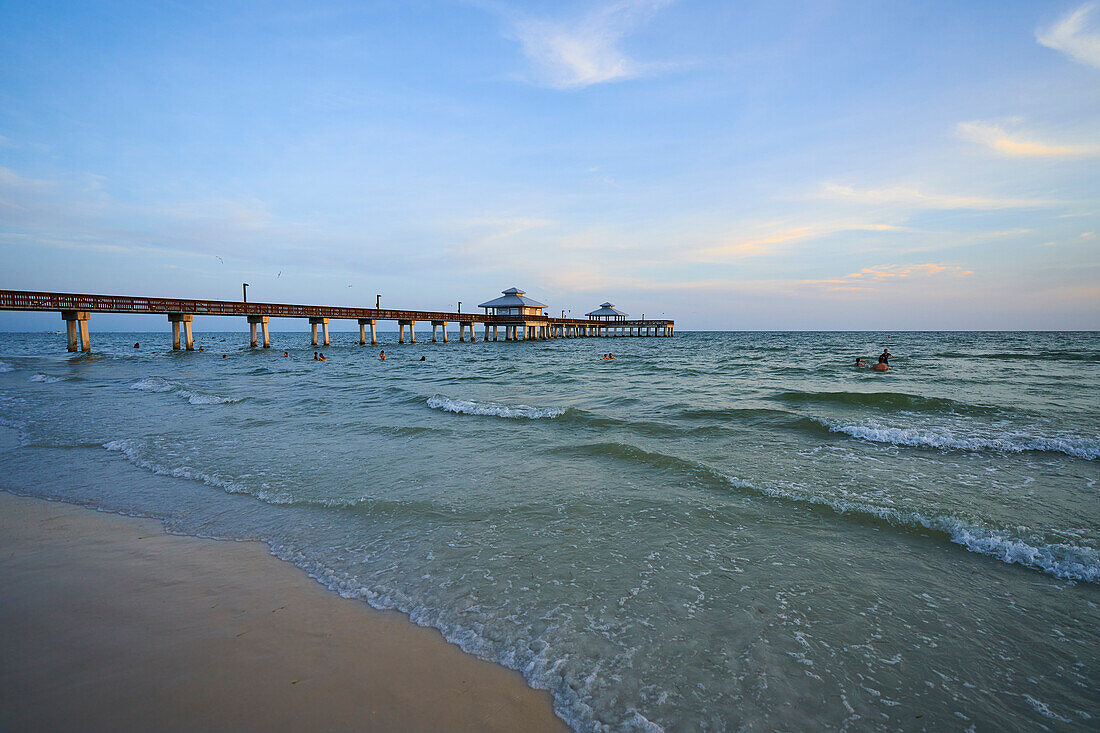 USA, Florida, Fort Myers Beach. Fort Myers Beach Pier at sunset. Located on Estero Island, Fort Myers Beach is a major tourist destination in Florida.
