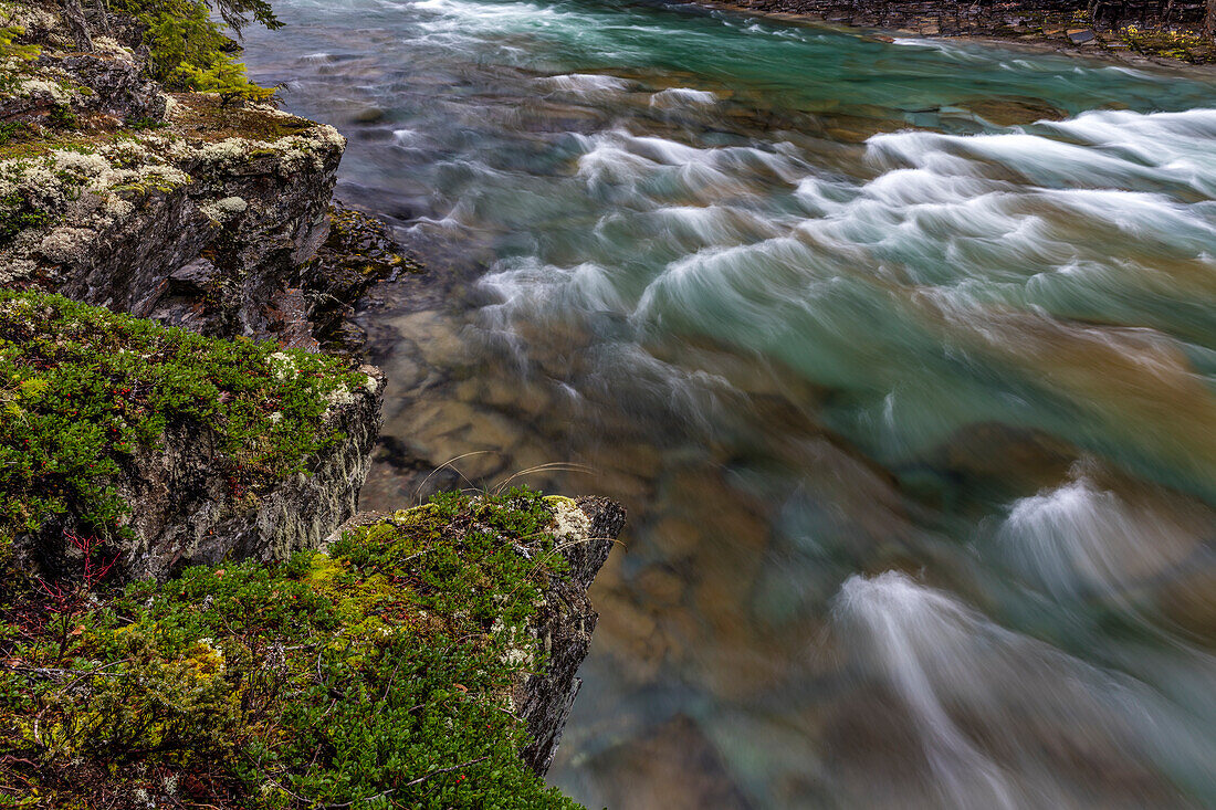 Mossy cliffs above rapids in McDonald Creek in Glacier National Park, Montana, USA