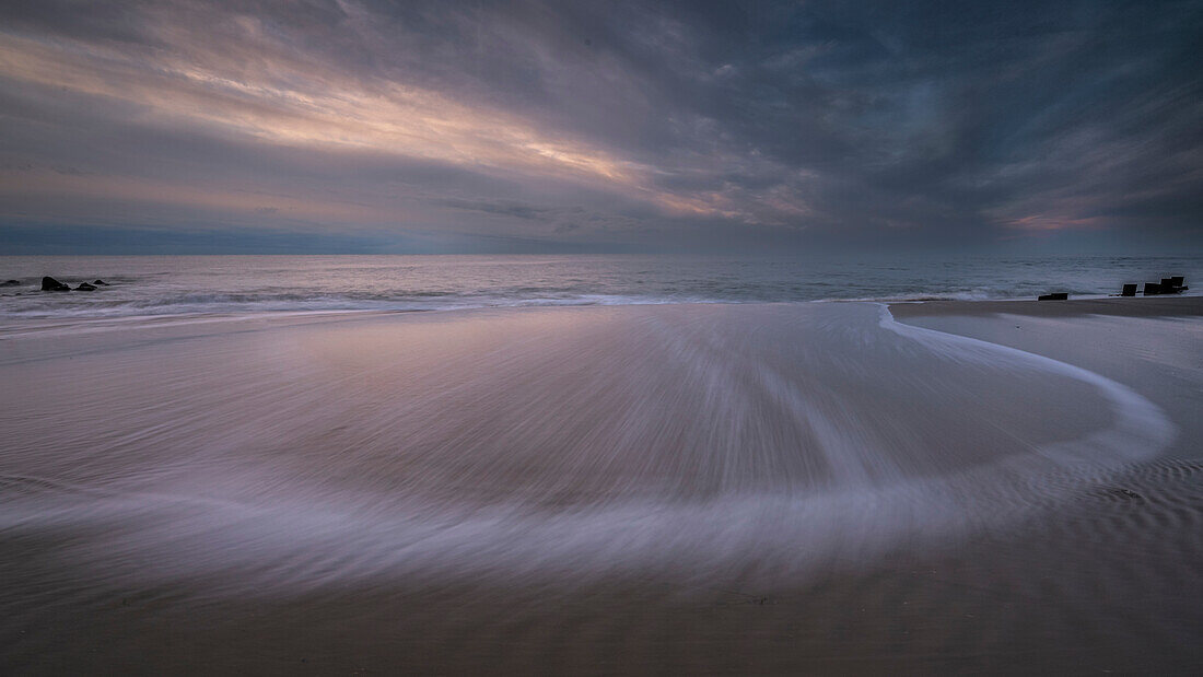 USA, New Jersey, Cape May National Seashore. Sunset on ocean and beach scenic.